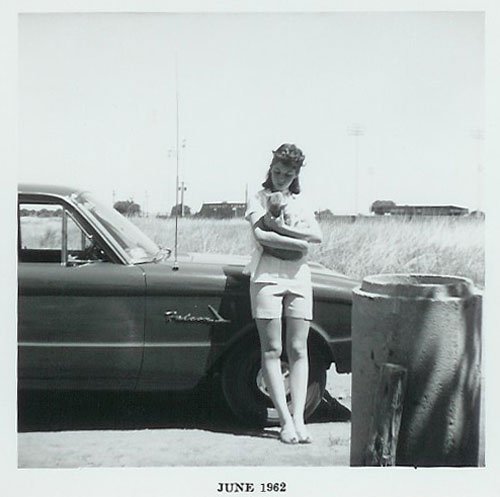 Sue Bradford with cat in front of Martin's 1961 Ford Falcon
