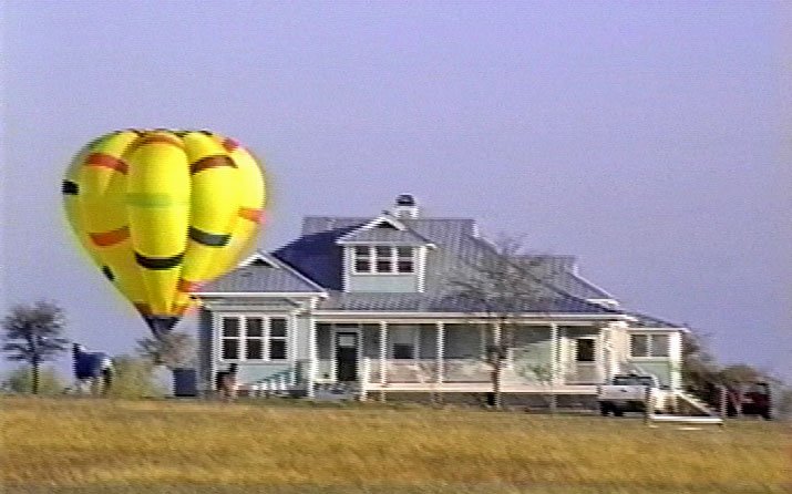 Rusty' balloon & house near Austin