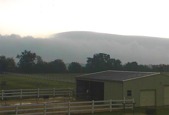 picture of clouds behind stable